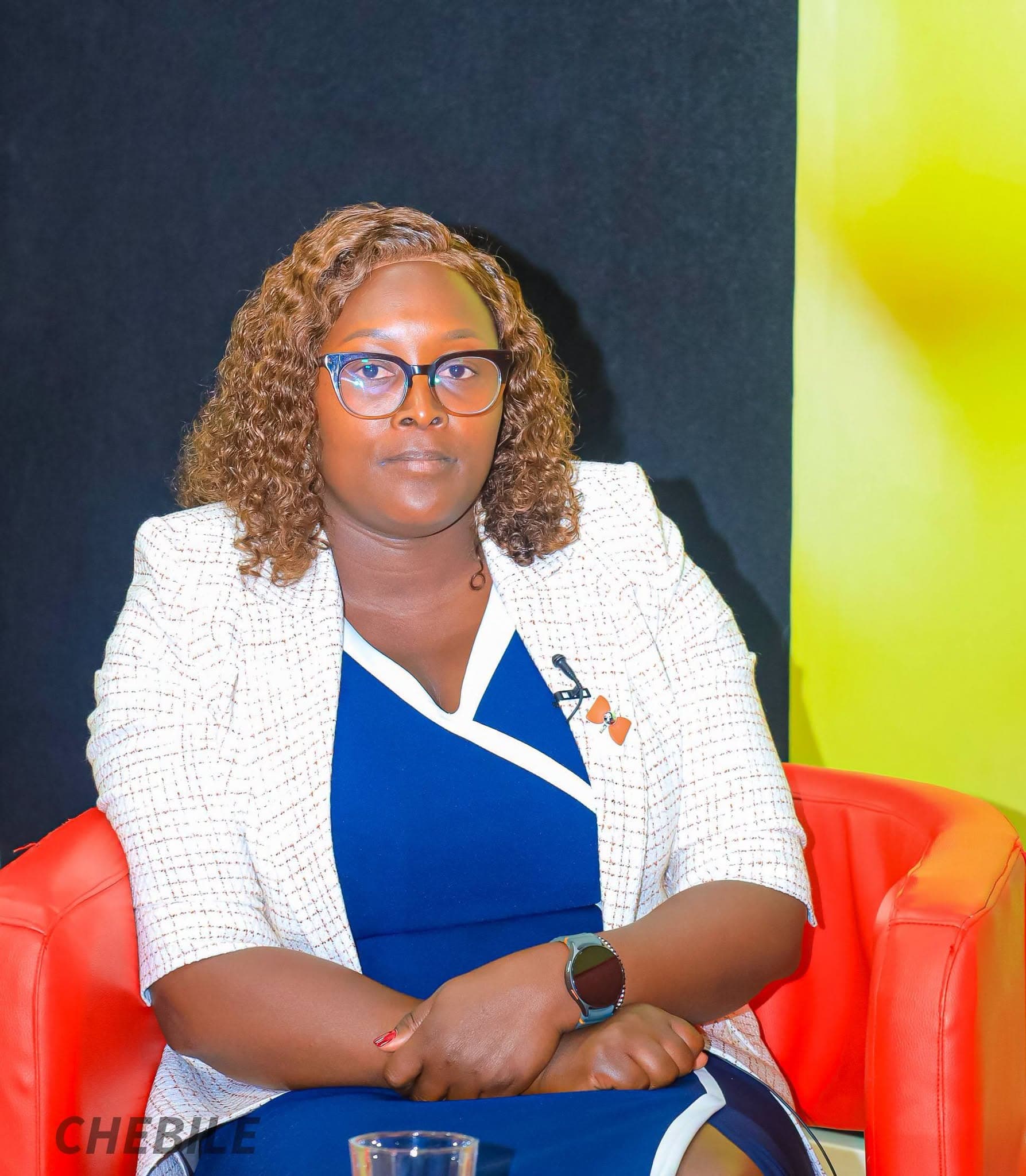 Irine Chebile seated during a media interview